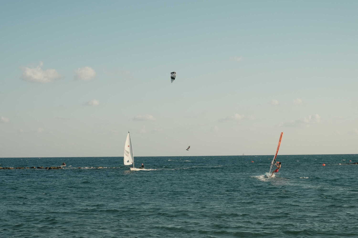 Photo of windsurfer jumping out of the ocean, off the coast of Limassol, Cyprus